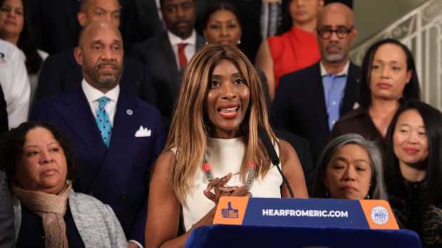 Asahi Pompey, Global Head of Corporate Engagement & President of the Goldman Sachs Foundation speaks next to Mayor Eric Adams during press conference at City Hall Rotunda Monday March 4, 2024. (Luiz C. Ribeiro for NY Daily News)